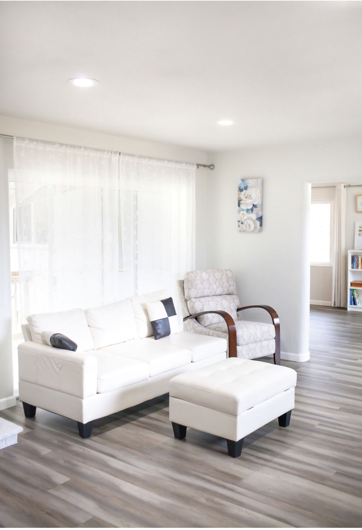Sunlit living room with a cream sofa at Everyday Grace’s Des Moines home