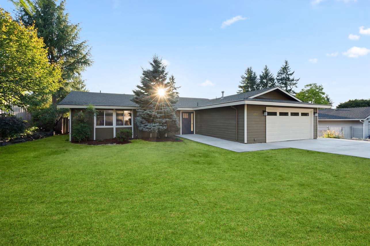 Exterior of the 35th Avenue home with lawn and trees
